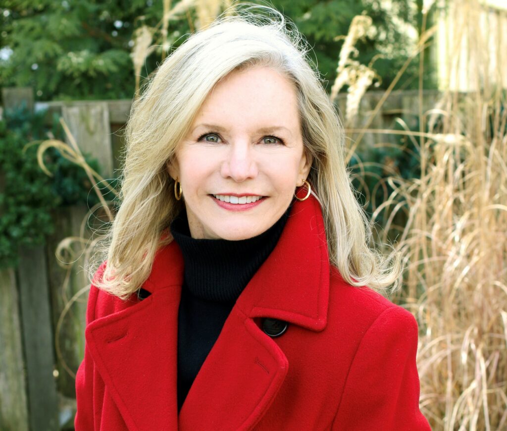 Joanne Irving in a red coat.